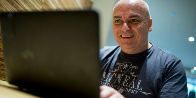 This Friday, Aug. 3, 2012 photo shows Irish national Colin Manning sits in front of a laptop computer in Berlin, Germany. Citizens from the European Union are free to live and work in any of its 27 member states, but broadcast services are still strictly limited by national boundaries. Manning, who has lived in Germany for more than a decade, fumed about a system he described as âcompletely mad in the digital age.â An avid fan of Irish sports, the 51-year-old has turned to the gray area of 'virtual private networks' to get his fix of hurling and Gaelic football. For $10 a month VPN services allow users to make their computer appear like it's somewhere else on the Internet, giving them access to NBC, the BBC or in Manning's case, Irish broadcaster RTE. (AP Photo/Gero Breloer)