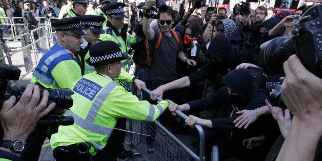 Protesters demonstrate against the Conservative government outside Downing Street in Westminster, London, Saturday, May 9, 2015. David Cameron's Conservative Party swept to power Friday in Britain's Parliamentary General Elections, winning an unexpected majority. (AP Photo/Tim Ireland)