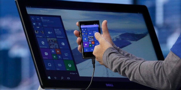 Joe Belfiore, Microsoft Corporate Vice President of Operating Systems Group, demonstrates Continuum for phones at the Microsoft Build conference in San Francisco, Wednesday, April 29, 2015. While Microsoft has already previewed some aspects of the new Windows 10, a parade of top executives will use the conference to demonstrate more software features and app-building tools, with an emphasis on mobile devices as well as PCs. (AP Photo/Jeff Chiu)