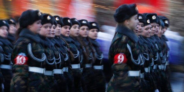 In this photo taken late Friday, Nov. 1, 2013, Russian girl cadets dressed in Red Army World War II uniform attend a rehearsal for the Nov. 7 parade in the Red Square in Moscow, Russia. The parade marks the 72nd anniversary of a Nov. 7 parade on Red Square when soldiers went directly to the front during World War II. For decades Nov. 7 was a holiday celebrating the 1917 Bolshevik Revolution. (AP Photo/Denis Tyrin)