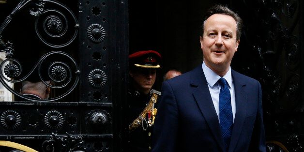 Britain's Prime Minister David Cameron returns to 10 Downing Street in London after attending a VE Day service at the Cenotaph, Friday, May 8, 2015. Cameron's Conservative Party swept to power Friday in Britain's Parliamentary elections winning an unexpected majority. (AP Photo/Kirsty Wigglesworth)