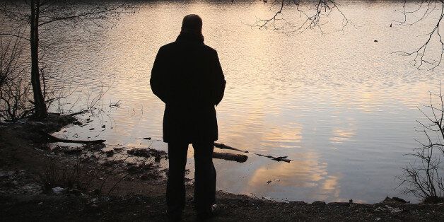 BERLIN, GERMANY - DECEMBER 28: A man stands as a silhouette next to Schlachtensee Lake at sunset on December 28, 2014 in Berlin, Germany. Depression affects a large portion of the population and frequently goes unreported. (Photo by Sean Gallup/Getty Images)