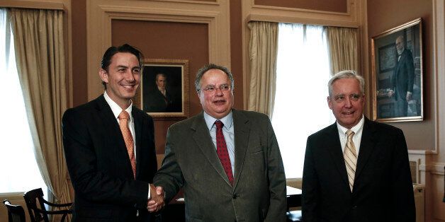 Amos Hochstein, left, U.S. State Department Special Envoy for International Energy Affairs, shakes hands with Greek Foreign Minister Nikos Kotzias, center, as U.S. Ambassador to Athens David D. Pearce, looks on, in Athens, Greece, on Friday, May 8, 2015. Hochstein is in Athens to hold talk with government officials over energy issues. (AP Photo/Yorgos Karahalis)