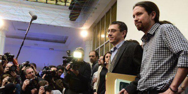 Spanish leader of Podemos Pablo Iglesias (R) and Spanish Secretary of Constituent Process and Programme of Podemos, Juan Carlos Monedero (2nd R), pose for photographers prior to giving a press conference in Madrid on February 20, 2015. Political science professor and founder of Podemos, Juan Carlos Monedero, finds himself embroiled in allegations of tax irregularities that forced him to publish his bank statements in an effort to silence critics. AFP PHOTO / JAVIER SORIANO (Photo credit