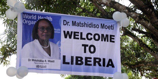 A banner welcomes the director of the World Health Organization (WHO) for the Africa region, Matshidiso Moeti during a visit to Zuma Town on the outskirts of the capital Monrovia, on April 22, 2015. Liberia is one of three countries, together with Guinea and Sierra Leone, that were ravaged by the worst outbreak of Ebola in history. The epidemic has killed at least 10,600 people since December 2013, some 500 of them healthcare workers. AFP PHOTO / ZOOM DOSSO (Photo credit should read ZOOM