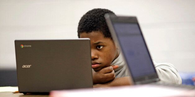 In this Feb. 12, 2015 photo, Marquez Allen, age 12, reads test questions on a laptop computer during in a trial run of a new state assessment test at Annapolis Middle School in Annapolis, Md. The new test, which is scheduled to go into use March 2, 2015, is linked to the Common Core standards, which Maryland adopted in 2010 under the federal No Child Left Behind law, and serves as criteria for students in math and reading. (AP Photo/Patrick Semansky)