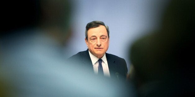 Mario Draghi, President of the European Central Bank (ECB) addresses the media during a press conference following the meeting of the Governing Council in Frankfurt/Main, Germany, on April 15, 2015. A news conference by European Central Bank president Mario Draghi in the bank's headquarters was briefly interrupted Wednesday when a young woman charged at Draghi calling for an 'end to the ECB dictatorship'. AFP PHOTO / DANIEL ROLAND (Photo credit should read DANIEL ROLAND/AFP/Getty Images)