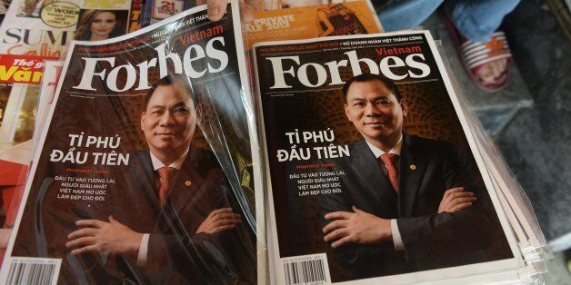 A copy of the newly launched Vietnamese version of Forbes Magazine is seen on sale at a roadside newsstand in Hanoi on June 26, 2013. The Southeast Asian communist nation's first Forbes-recognised billionaire Pham Nhat Vuong is on the cover of the inaugural issue. AFP PHOTO/HOANG DINH Nam (Photo credit should read HOANG DINH NAM/AFP/Getty Images)