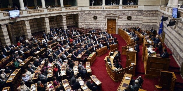 Leader of the main opposition leftist Syriza party, Alexis Tsipras speaks at the Greek parliament in Athens on October 10, 2014 as lawmakers debate prior the vote of confidence later tonight. Greek Prime Minister Antonis Samaras requested a vote of confidence , to douse speculation about early elections. AFP PHOTO/ LOUISA GOULIAMAKI (Photo credit should read LOUISA GOULIAMAKI/AFP/Getty Images)