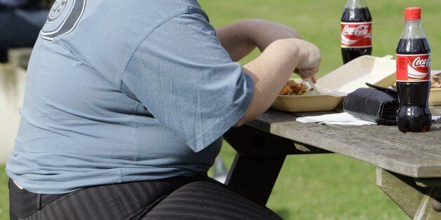 FILE- In this file photo dated Wednesday, Oct. 17, 2007, an overweight person eats in London, Wednesday, Oct. 17, 2007. Almost a third of the world population is now fat, and no country has been able to curb obesity rates in the last three decades, according to a new global analysis released Thursday May 29, 2014, led by Christopher Murray of the Institute for Health Metrics and Evaluation at the University of Washington, USA, and paid for by the Bill & Melinda Gates Foundation. Researchers reviewed more than 1,700 studies covering 188 countries covering over three decades and found more than 2 billion people worldwide classified as overweight or obese. The highest rates of obesity were found in the Middle East and North Africa, with the U.S. having about 13 percent of the worldâs fat population. (AP Photo/Kirsty Wigglesworth, FILE)