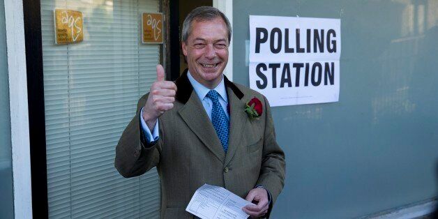 Nigel Farage the leader of the UK Independence Party (UKIP) poses for photographers as he arrives to cast his vote at a polling station in Ramsgate, south east England, Thursday, May 7, 2015. Polls have opened in Britain's national election, a contest that is expected to produce an ambiguous result, a period of frantic political horse-trading and a bout of national soul-searching. (AP Photo/Matt Dunham)