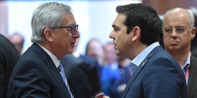 European Commission President Jean-Claude Juncker (L) speaks with Greek Prime Minister Alexis Tsipras as they take part in an emergency meeting to discuss Europe's response to the Mediterranean migrants crisis at the European Council in Brussels, April 23, 2015. AFP PHOTO/EMMANUEL DUNAND (Photo credit should read EMMANUEL DUNAND/AFP/Getty Images)