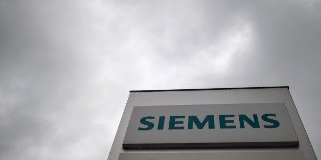 The logo of German engineering giant Siemens is pictured on May 7, 2015 in Muelheim, Germany. German engineering giant Siemens said on Thursday that it would slash an additional 4,500 jobs worldwide, on top of 7,400 cuts previously announced as part of an ongoing restructuring plan. AFP PHOTO / DPA / MAJA HITIJ +++ GERMANY OUT (Photo credit should read MAJA HITIJ/AFP/Getty Images)