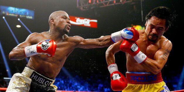 LAS VEGAS, NV - MAY 02: Floyd Mayweather Jr. throws a left at Manny Pacquiao during their welterweight unification championship bout on May 2, 2015 at MGM Grand Garden Arena in Las Vegas, Nevada. (Photo by Al Bello/Getty Images)