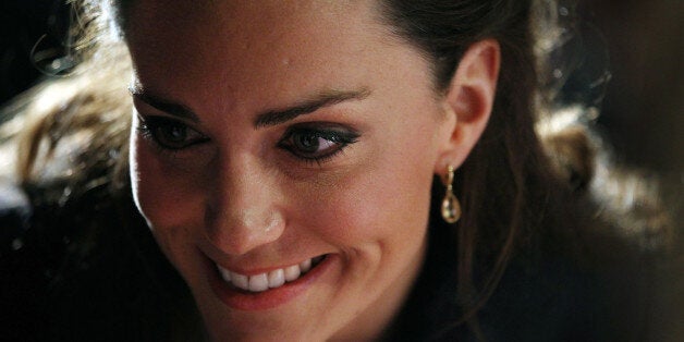 Kate Middleton, fiancee of Britain's Prince William, leans in to talk with a student following a dance show during a visit with William to Darwen Aldridge Community Academy in Darwen, north-west England, on April 11, 2011. The couple were at the academy to officially open the centre and also to launch the SkillForce Prince's Award. The SkillForce Prince's Award is to recognise the contribution that young people make to their communities. Prince William will marry Kate Middleton at Westminster Abbey in London, on April 29, 2011. AFP PHOTO/ADRIAN DENNIS/WPA POOL/AFP (Photo credit should read ADRIAN DENNIS/AFP/GettyImages)