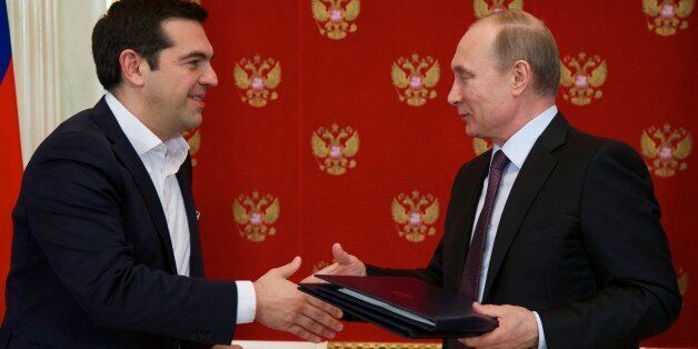 Russian President Vladimir Putin, right, and Greek Prime Minister Alexis Tsipras exchange documents during a signing ceremony in the Kremlin in Moscow, Russia, Wednesday, April 8, 2015. Russian President Vladimir Putin said the leader of Greece did not ask for financial aid during an official visit, easing speculation that Athens might use its relations with Moscow to gain advantage in bailout talks with European creditors. (AP Photo/Alexander Zemlianichenko, pool)