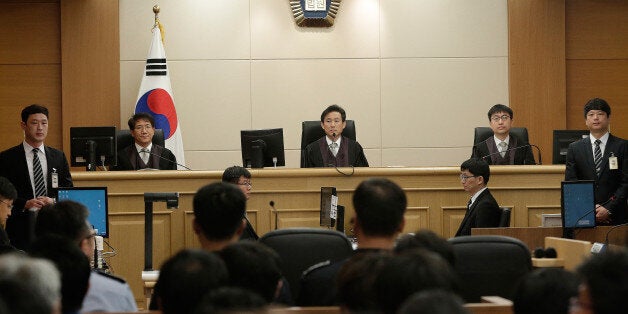 GWANGJU, SOUTH KOREA - APRIL 28: Judges sit to preside over verdicts of the sunken South Korean ferry Sewol's crew members are charged with negligence and abandonment of passengers in the disaster at the Gwangju High Court on April 28, 2015 in Gwangju, South Korea. The appeal trial concluded life in prison to the captain of Sewol ferry, jailed over the sinking that claimed more than 300 lives. (Photo by Ahn Young-Joon - Pool/Getty Images)