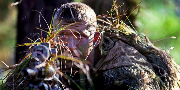 Army Staff Sgt. Mathew Fox waits to engage a target in the live-fire stalk event during the 2012 International Sniper Competition at the U.S. Army Sniper School on Fort Benning, Ga., Nov. 3, 2012. Fox, a sniper, is assigned to the 3rd Infantry Division's 3rd Brigade, 2nd Battalion, 69 Armor Regiment. U.S. Army photo by Ashley Cross