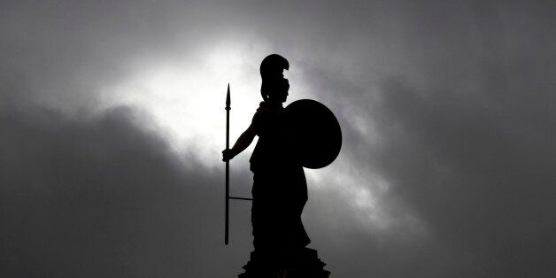The 19th century statue of the ancient goddess Athena stands at the Athens Academy on Friday, March 27,...