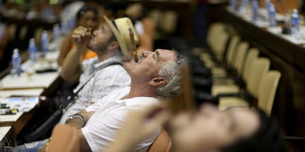 HAVANA, CUBA - FEBRUARY 26: Smokers participate in the cigar smoking competition to see who could make the longest ash during the week-long International Habano Cigar Festival on February 26, 2015 in Havana, Cuba. The annual cigar festival attracts tourists from around the world to sample the islands world renowned tobacco. (Photo by Joe Raedle/Getty Images)