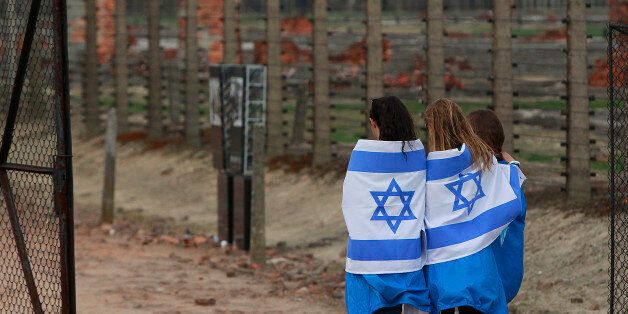 Participants with Israeli flags arrive for the annual silent March of the Living at the Auschwitz-Birkenau Nazi death camp memorial to honor more than 1 million people, mostly Jews, killed at the camp from 1940-45, in Oswiecim, Poland, Thursday, April 16, 2015. (AP Photo/Czarek Sokolowski)