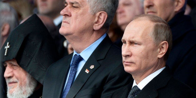 From left, Armenian Apostolic Church leader, Catholicos Garegin II, Serbian President Tomislav Nikolic and Russian President Vladimir Putin attend a ceremony at the Tsitsernakaberd Genocide memorial complex in Yerevan, Armenia, Friday, April 24, 2015. On Friday, Armenians mark the centenary of what historians estimate to be the slaughter of up to 1.5 million Armenians by Ottoman Turks, an event widely viewed by scholars as genocide. Turkey, however, denies the deaths constituted genocide and says the death toll has been inflated. Russian President Vladimir Putin, French President Francois Hollande and other dignitaries assembled Friday morning at the Tsitsernakaberd memorial complex in the capital, Yerevan. (Alexei Nikolsky/RIA Novosti, Kremlin Pool Photo via AP)