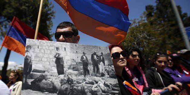 Members of the Armenian community hold the Armenian flags and placards during a demonstration on April 24, 2015 infront of the Turkish consulate in Jerusalem, to commemorate the 100th anniversary of the mass killings of Armenians under the Ottoman Empire in 1915. Armenia says an estimated 1.5 million people were killed by Ottoman forces in what it calls a genocide. AFP PHOTO/GALI TIBBON (Photo credit should read GALI TIBBON/AFP/Getty Images)