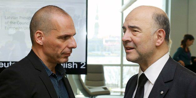 Greek Finance Minister Yanis Varoufakis, left, and Commissioner for Economic and Financial Affairs, Taxation and Customs, Pierre Moscovici speak at the Informal Meeting of Ministers for Economic and Financial Affairs of the European Union in Riga, Latvia on Friday, April 24, 2015. Greece's finance minister came under fire Friday from his peers in the 19-country eurozone for failing to come up with a comprehensive list of economic reforms that are needed if the country is to get vital loans to av