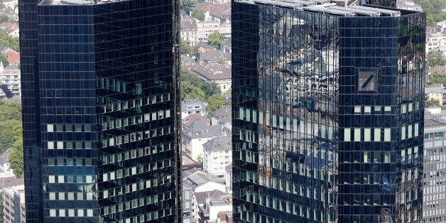 Deutsche Bank headquarters in Frankfurt, Germany, photographed Monday, May 19, 2014. Deutsche Bank AG says raising 8 billion euros (US $11 billion) in new capital from investors will strengthen its finances as it faces tighter regulation and uncertain costs from litigation. (AP Photo/Michael Probst)