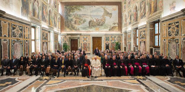 In this Friday, April 17, 2015 pool photo Pope Francis, left, meets members of the Papal Foundation during an audience at the Vatican. (L'Osservatore Romano/Pool Photo via AP)