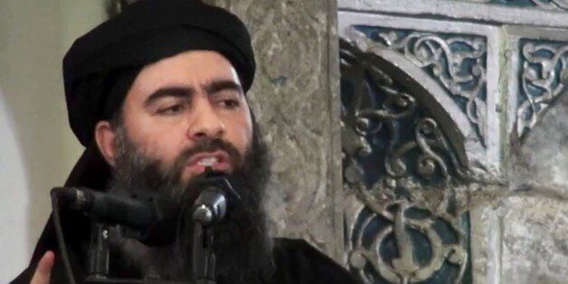 FILE - This file image made from video posted on a militant website Saturday, July 5, 2014, which has been authenticated based on its contents and other AP reporting, purports to show the leader of the Islamic State group, Abu Bakr al-Baghdadi, delivering a sermon at a mosque in Iraq during his first public appearance. (AP Photo/Militant video, File)
