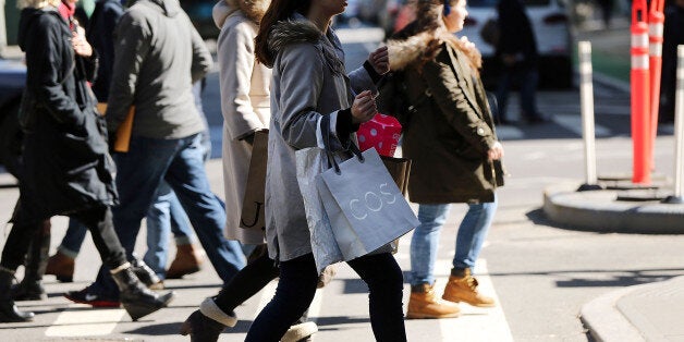 NEW YORK, NY - MARCH 12: People walk with shopping bags in Manhattan on March 12, 2015 in New York City. For a third straight month in February U.S. retail sales unexpectedly fell according to a report by the Commerce Department released on Thursday. The report said that retail sales dropped 0.6 percent, with receipts falling in almost all categories. (Photo by Spencer Platt/Getty Images)