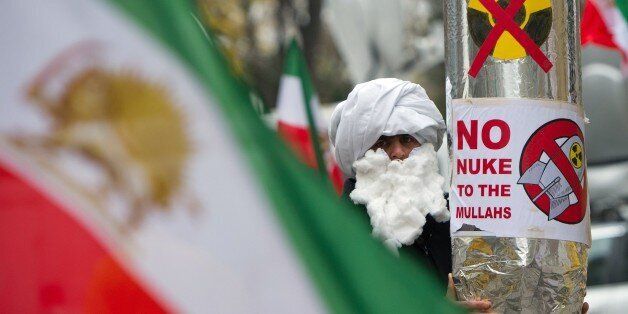 A demonstrator holds a mock-up of a nuclear missile with the lettering 'No nuke to the mullahs' as he protests against Iran's nuclear program and regime in front the Palais Coburg in Vienna on November 22, 2014, where nuclear talks with Iran are to take place. At stake in the Austrian capital Vienna is a historic deal in which Iran would curb its nuclear activities in exchange for broad relief from years of heavy international economic sanctions. It could end a 12-year standoff with the West tha