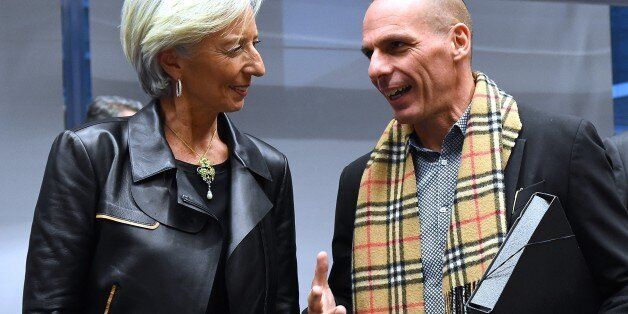 Greek Finance Minister Yanis Varoufakis (R) speaks with International Monetary Fund (IMF) Director Christine Lagarde during an emergency Eurogroup finance ministers meeting at the European Council in Brussels on February 11, 2015. Proposals by the new government in Athens to renegotiate the terms of its massive international bailout are scheduled to be discussed by eurozone finance ministers in Brussels on February 11 and 12. AFP PHOTO / EMMANUEL DUNAND (Photo credit should read EMMANUEL