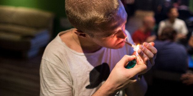 BARCELONA, SPAIN - AUGUST 22: Alejandro lights a marijuana joint in a cannabis club on August 22, 2014 in Barcelona, Spain. Under Spanish law marijuana can be consumed and grown for personal use. According to self-regulated Cannabis Associations of Catalonia (FEDCAC) and Cannabis Associations Federation of Catalonia (CATFAC) there are currently more than 650 cannabis clubs in Spain, 55 of which are regulated under the Code of Good Practice by these associations. The clubs are for members only, who have to be Spanish residents over 21 years of age, and who are introduced to the club by an existing member. More than half of the cannabis clubs can be found in Barcelona, where authorities are have imposed a one-year moratorium on new licenses for cannabis associations and it is searching for new ways to regulate these clubs as they are becoming increasingly popular. (Photo by David Ramos/Getty Images)