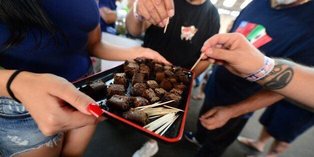 Care-carrying medical marijuana patients sample the brownies at Los Angeles' first-ever cannabis farmer's market at the West Coast Collective medical marijuana dispensary, on the fourth of July, or Independence Day, in Los Angeles, California on July 4, 2014 where organizer's of the 3-day event plan to showcase high quality cannabis from growers and vendors throughout the state. AFP PHOTO/Frederic J. BROWN (Photo credit should read FREDERIC J. BROWN/AFP/Getty Images)