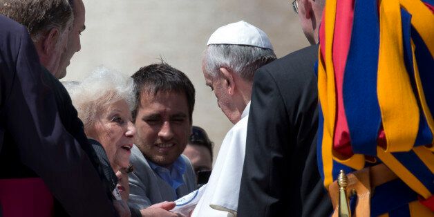Leader of the Grandmothers of the Plaza de Mayo Estela do Carlotto, left, and Juan Cabandie, a recovered grandson, center, meet with Pope Francis at the end of his weekly general audience in St. Peter's Square at the Vatican, Wednesday April 24, 2013. Representatives from
