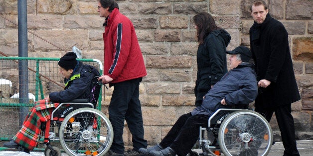 TITISEE-NEUSTADT, GERMANY - DECEMBER 01: Wheelchairs are pushed outside of Muenster St. Jakobus church as a memorial service is held for 14 people who died in a fire at a Caritas employment facility for the handicapped on December 1, 2012 in Titisee-Neustadt, Germany. The fire was reportedly caused by an explosion at the facility, where approximately 120 people with disabilities are employed in light manufacturing. (Photo by Harold Cunningham/Getty Images)