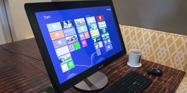 This April 24, 2014 photo shows the ASUS All-in-One PC ET2322 desktop computer, in Decatur, Ga. The computer has a touch-sensitive, 23-inch display. (AP Photo/Ron Harris)