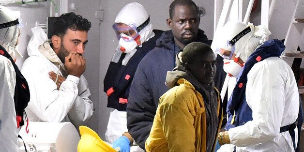 CATANIA, ITALY - APRIL 20: (L) Tunisian skipper Mohammed Ali Malek stands on the deck of the Italian Coast Guard ship Gregretti which is carrying 27 survivors of the migrant shipwreck in the mediterranean, at Catania port on April 20, 2015 in Catania, Italy. The weekend saw the worst disaster of its kind as hundreds of migrants are believed to have perished as they attempted to cross the mediterranean from Libya to Italy in order to seek refuge. Tunisian skipper Mohammed Ali Malek, was arrested