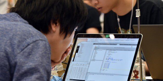 Some 90 participants in 24 teams from seven nations and regions from China, Japan, Poland, Russia, South Korea, Taiwan, and the United States compete in their hacking skills at the final rounds of the Security Contest 2014, SECCON on February 7, 2015. A cyber security competition began in Tokyo, with organisers aiming to show off the skills of young Japanese hackers by seeing how they fare against foreign rivals. AFP PHOTO / Yoshikazu TSUNO (Photo credit should read YOSHIKAZU TSUNO/AFP/Getty Images)