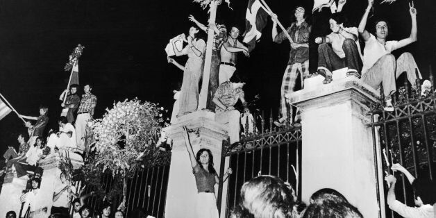 GREECE - AUGUST 27: Greeks celebrating the capitulation of the military dictatorship before the polytechnic school in Athens on July 26, 1974. The civil government of Prime Minister Constantine KARAMANLIS replaced the dictatorship. (Photo by Keystone-France/Gamma-Keystone via Getty Images)