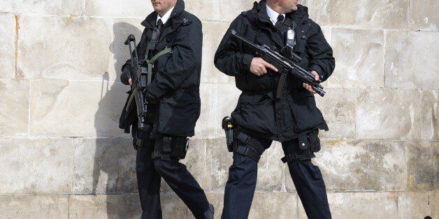 Armed British police officers patrol outside St Paul's Cathedral in London on March 13, 2015, ahead of a memorial service to mark the end of Britain's combat operations in Afghanistan. AFP PHOTO / JUSTIN TALLIS (Photo credit should read JUSTIN TALLIS/AFP/Getty Images)