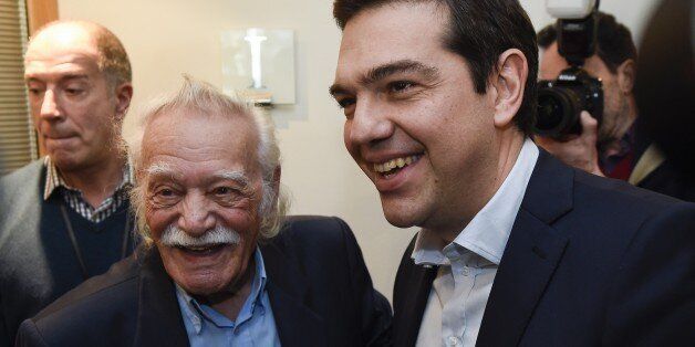 Greek member of the Confederal Group of the European United Left-Nordic Green Left party, Emmanouil Glezos (L), welcomes Greek Prime minister Alexis Tsipras (R) before their meeting at the European Parliament in Brussels on March 13, 2015. AFP PHOTO / JOHN THYS (Photo credit should read JOHN THYS/AFP/Getty Images)