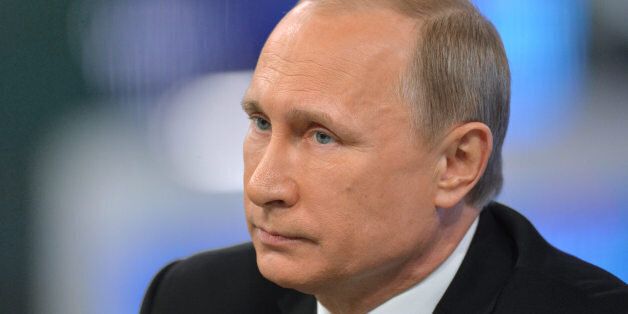 Russian President Vladimir Putin listens during an annual call-in show on Russian television