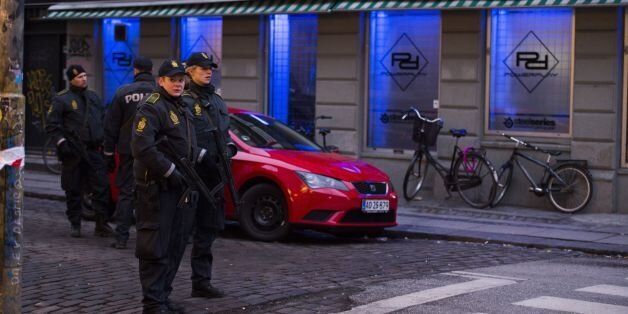 Armed police stand guard outside an internet cafe that was raided in connection with the twin attack on a freedom of expression meeting and the main Synagogue in Copenhagen on February 15, 2015. Two fatal shootings in the Danish capital, at a cultural center during a debate on Islam and free speech and a second outside the city's main synagogue. France's ambassador to Denmark Francois Zimeray, who was attending the debate, told AFP the attackers were seeking to replicate the January 7 assault by jihadists in Paris on satirical newspaper Charlie Hebdo that left 12 dead. AFP PHOTO / ODD ANDERSEN (Photo credit should read ODD ANDERSEN/AFP/Getty Images)