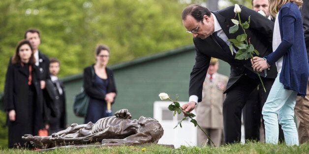 French President Francois Hollande, center, lays flowers during a ceremony to mark the 70th anniversary of the liberation of the camp Natzwiller-Struthof, eastern France, on Sunday April 26 2015. (AP Photo/Jean Francois Badias, Pool)