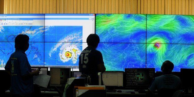 Meteorologists from the Philippine Atmospheric, Geophysical and Astronomical Services Administration (PAGASA) monitor and plot the direction of super typhoon Maysak at PAGASA headquarters in suburban Manila on April 1, 2015. The typhoon has already ravaged the Pacific islands and is expected to hit the Philippines this weekend. Government weather forecasters are hoping it will weaken before it slams into the northern part of the archipelago which is already frequently battered by typhoons. AFP