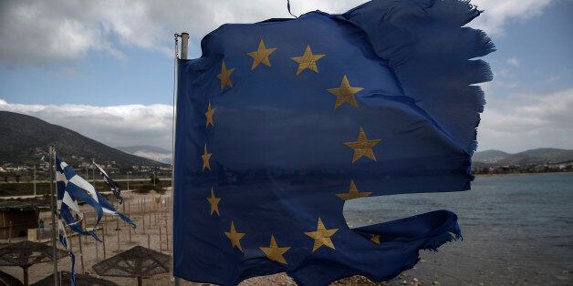 Ruined EU and Greek flags fly in tatters from a flag pole at a beach at Anavissos village, southwest of Athens, on Monday, March 16, 2015. Tensions between Greece, its eurozone partners and the institutions supervising the debt, the Commission, the European Central Bank and the IMF, have been heightened by the new government's continued election-style rhetoric and the EU's austerity demands. (AP Photo/Yorgos Karahalis)