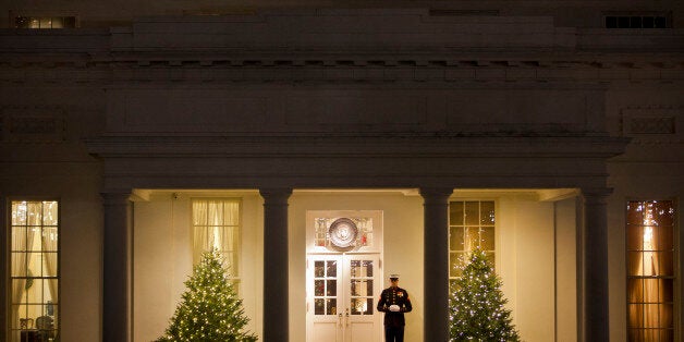 US Marine stands outside the West Wing of the White House in Washington, Friday, Dec. 12, 2014. Congress cleared a $1.1 trillion spending bill for Obama's signature late Saturday night after a day of Senate intrigue capped by a failed, largely symbolic Republican challenge to the administration's new immigration policy. (AP Photo/Pablo Martinez Monsivais)